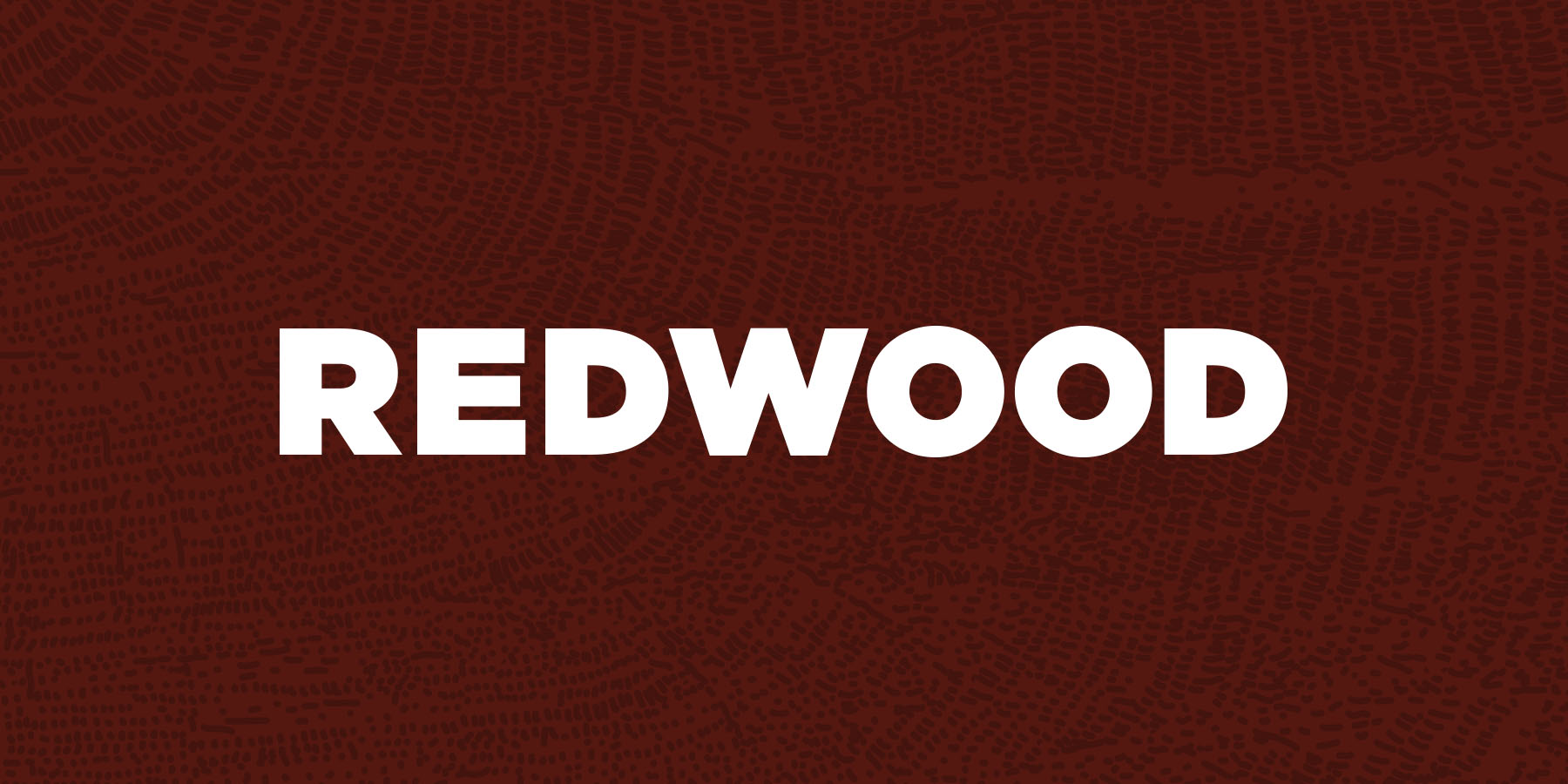 Redwood Housing logo wordmark on background tree ring texture